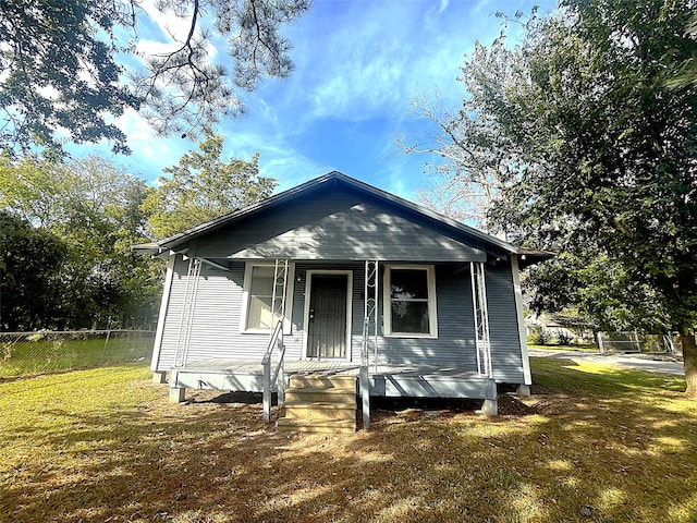 bungalow with a front lawn and a porch