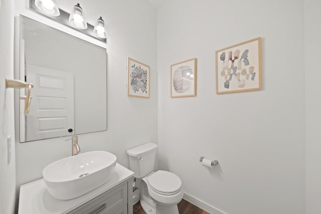 bathroom with vanity, hardwood / wood-style flooring, and toilet