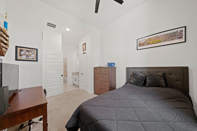 carpeted bedroom featuring ensuite bathroom, vaulted ceiling, and ceiling fan