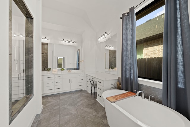 bathroom featuring vanity, vaulted ceiling, independent shower and bath, and tile patterned flooring