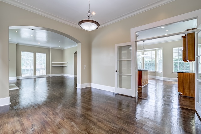 unfurnished room featuring crown molding and dark wood-type flooring