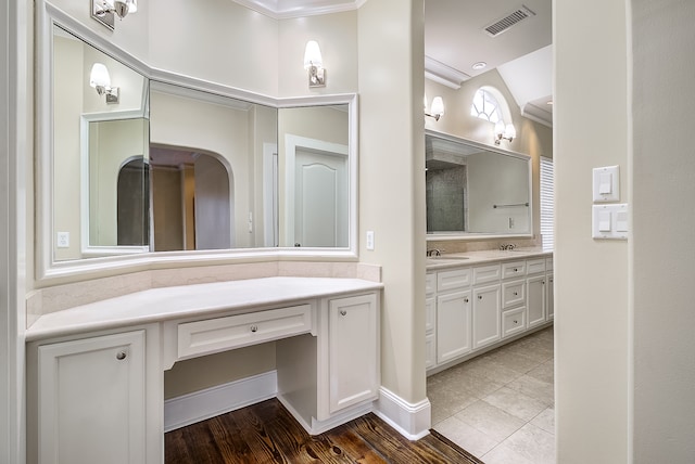 bathroom featuring vanity, crown molding, and hardwood / wood-style floors