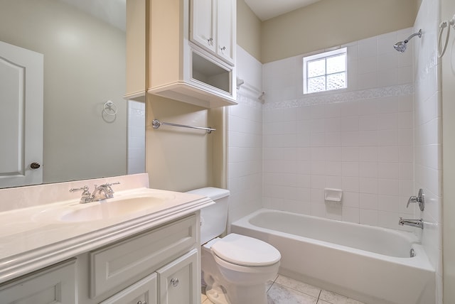 full bathroom featuring toilet, tiled shower / bath, vanity, and tile patterned floors