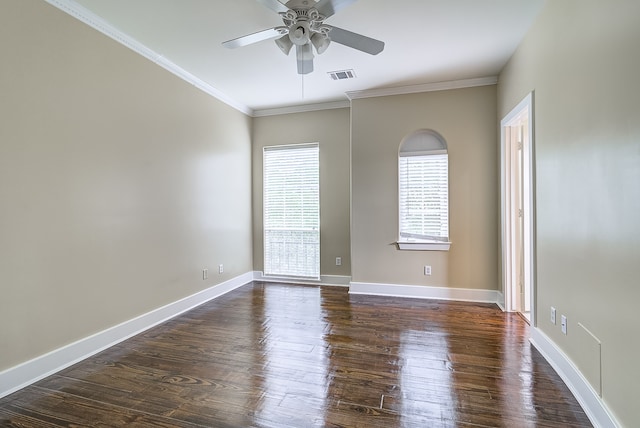 empty room with crown molding, dark hardwood / wood-style floors, and ceiling fan