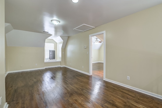 additional living space with lofted ceiling, dark hardwood / wood-style floors, and ceiling fan