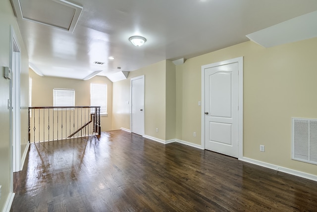 unfurnished room featuring dark wood-type flooring