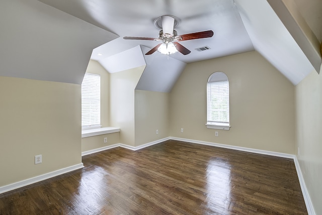 additional living space with vaulted ceiling, dark hardwood / wood-style floors, and ceiling fan