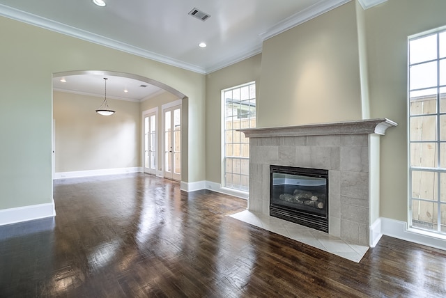 unfurnished living room featuring ornamental molding, hardwood / wood-style floors, and a fireplace