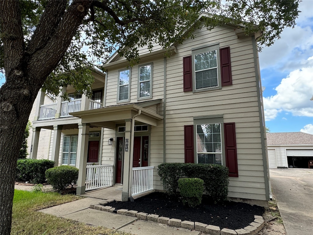 view of front of property featuring covered porch and a garage