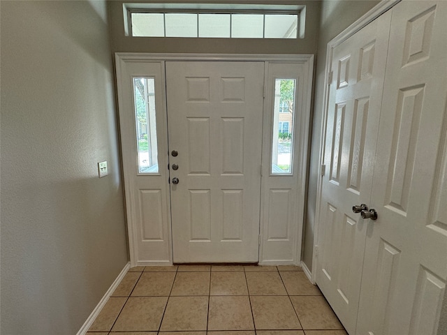 tiled entryway with a wealth of natural light