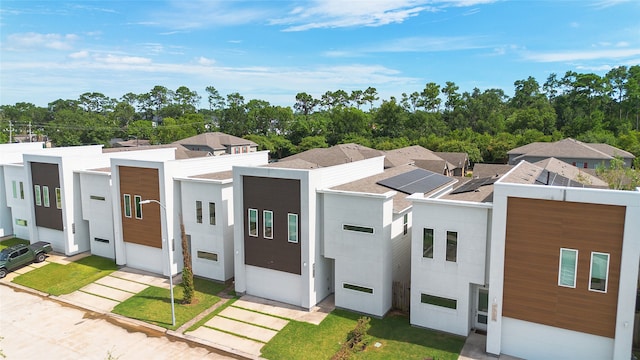 modern home featuring a front yard and a garage