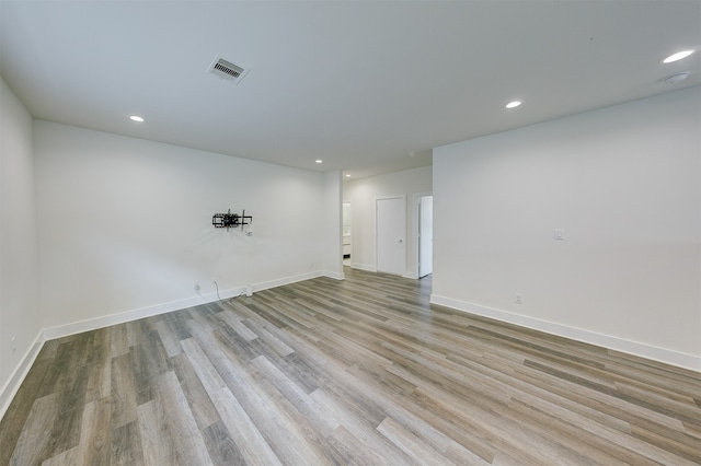 empty room with light hardwood / wood-style flooring