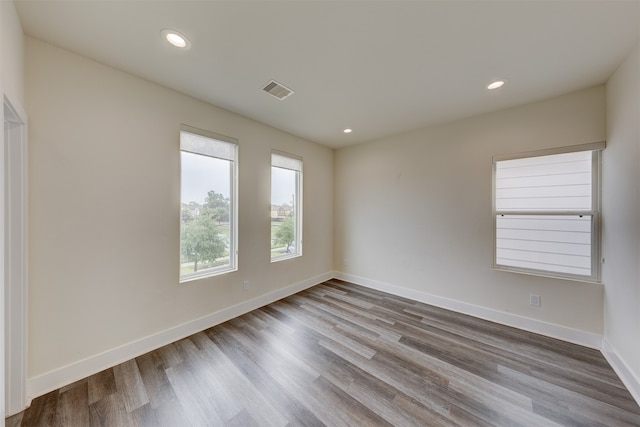 unfurnished room with wood-type flooring