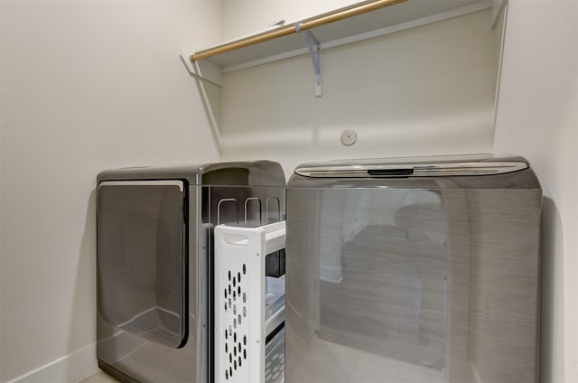 clothes washing area featuring washer and clothes dryer