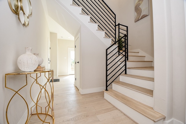 stairs featuring hardwood / wood-style floors