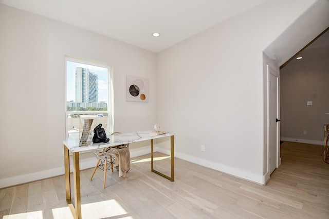 office area with light hardwood / wood-style floors