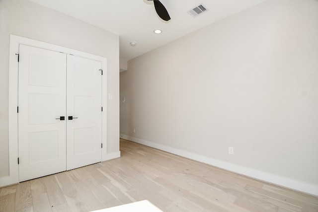 unfurnished bedroom with a closet, ceiling fan, and light hardwood / wood-style flooring