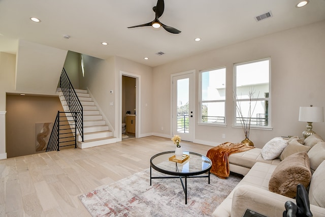 living room featuring light hardwood / wood-style floors and ceiling fan