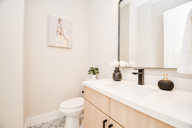 bathroom with vanity, toilet, and tile patterned floors