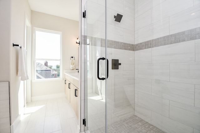 bathroom with vanity, tile patterned flooring, and a shower with door