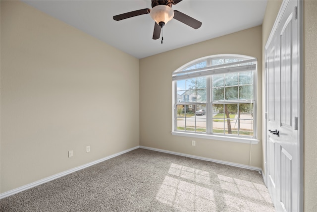 spare room with light carpet and ceiling fan