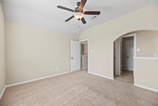 unfurnished bedroom featuring lofted ceiling, light colored carpet, and ceiling fan