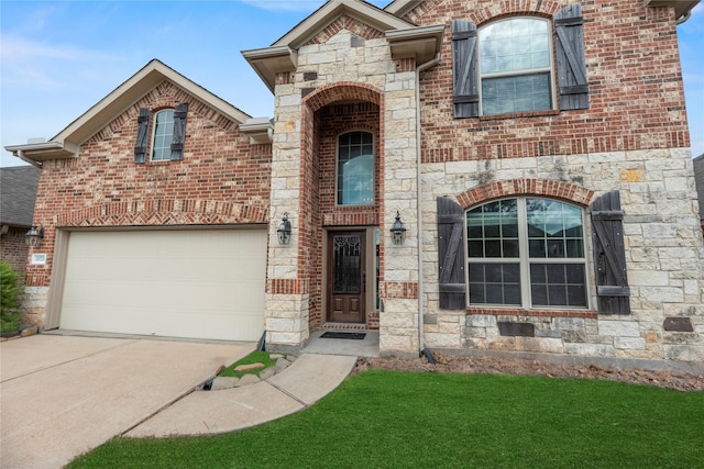 view of front of house with a garage and a front lawn