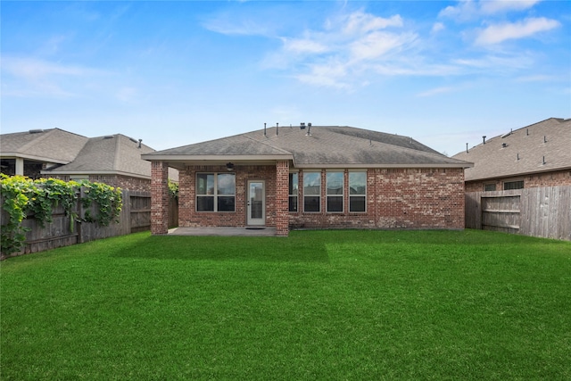 rear view of property with a patio area and a lawn