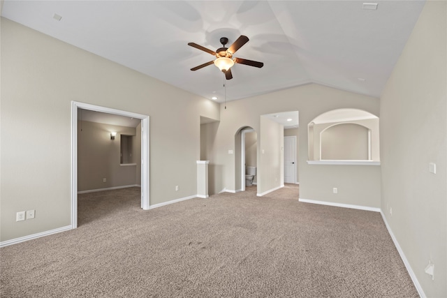 carpeted empty room with ceiling fan and lofted ceiling