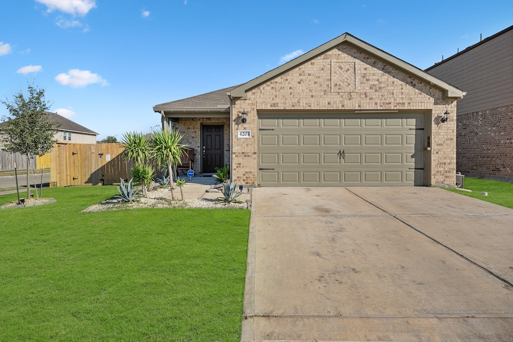 ranch-style home with a garage and a front lawn