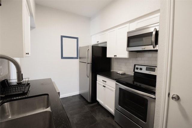 kitchen featuring backsplash, white cabinetry, sink, and stainless steel appliances