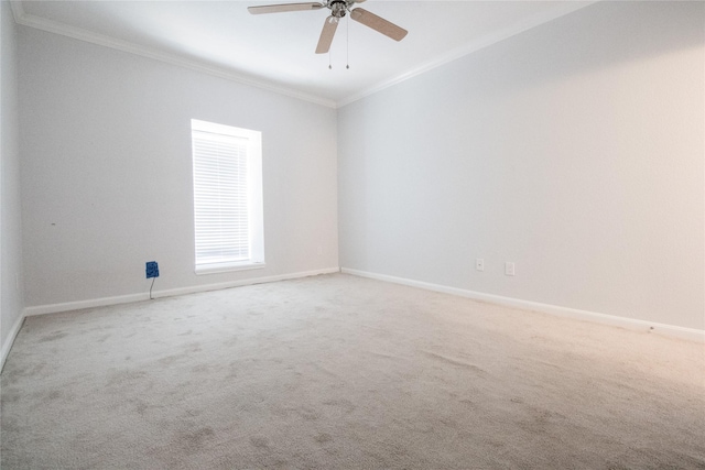 carpeted empty room featuring ceiling fan and crown molding