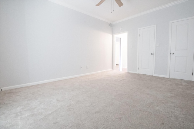 unfurnished bedroom with ceiling fan, crown molding, and carpet floors