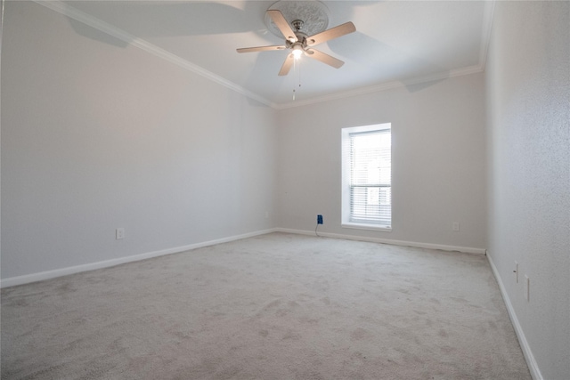 carpeted empty room featuring ceiling fan and crown molding