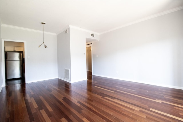 empty room with dark hardwood / wood-style flooring and ornamental molding