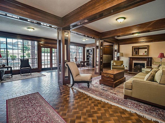 2400 N Braeswood Blvd Unit 314, Houston, TX 77030 - living room featuring a fireplace with flush hearth, a textured ceiling, and crown molding