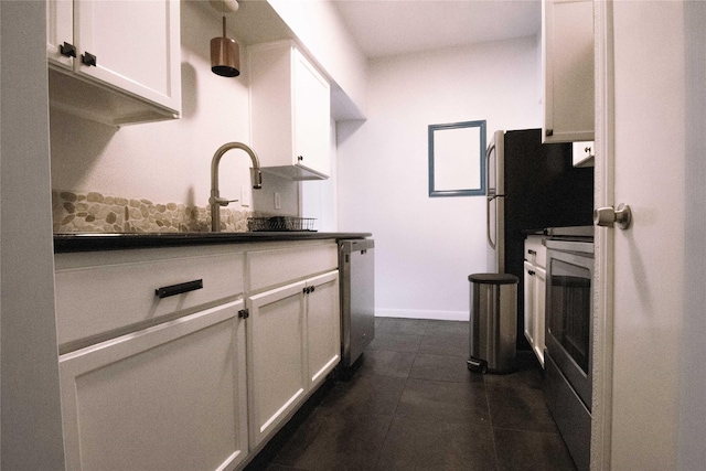 kitchen featuring white cabinetry, dishwasher, and sink