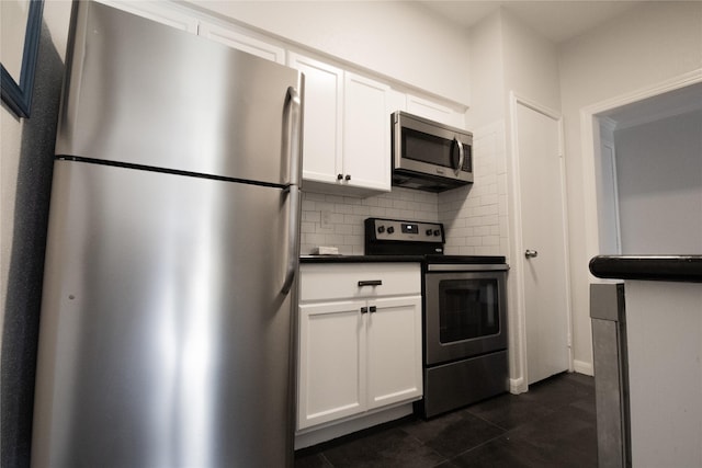 kitchen featuring decorative backsplash, stainless steel appliances, and white cabinetry