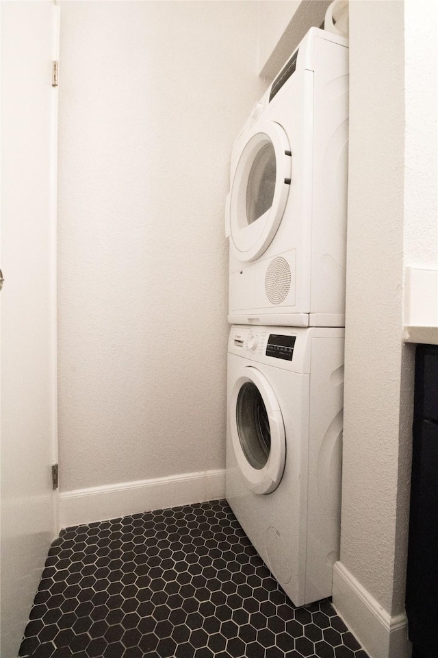 washroom with stacked washing maching and dryer