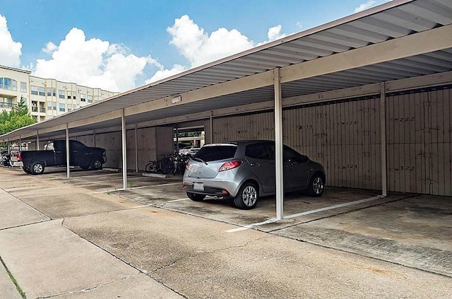 view of parking / parking lot featuring a carport