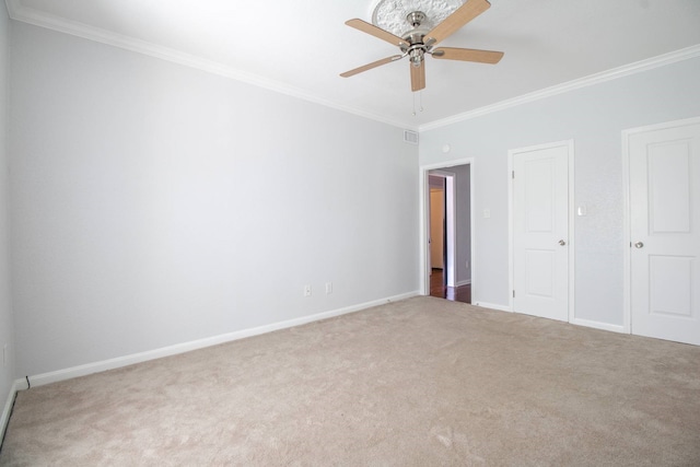 unfurnished bedroom featuring carpet, visible vents, a ceiling fan, ornamental molding, and baseboards