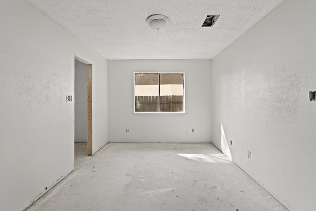 spare room featuring a textured ceiling