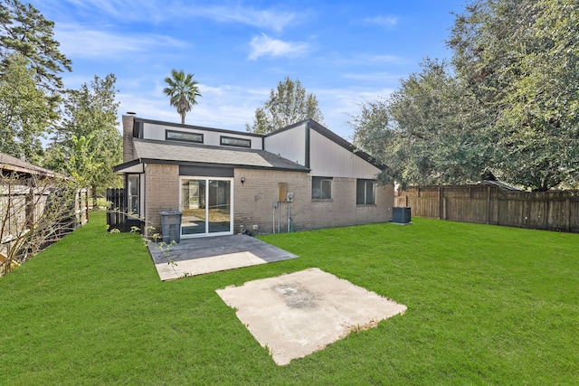 back of house featuring a patio and a yard