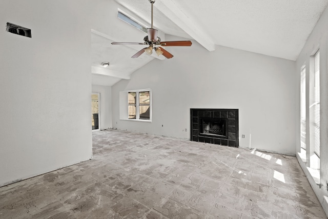 unfurnished living room with beam ceiling, a tile fireplace, a textured ceiling, high vaulted ceiling, and ceiling fan