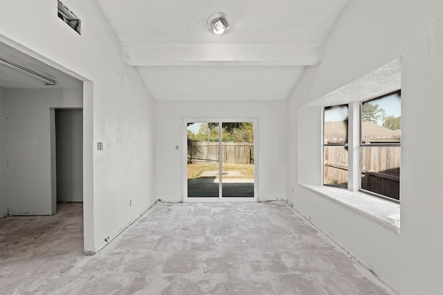 carpeted empty room with beamed ceiling and high vaulted ceiling