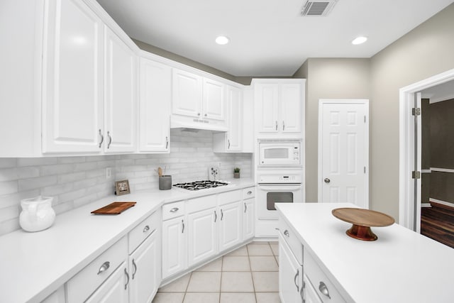 kitchen featuring white appliances, white cabinetry, and decorative backsplash