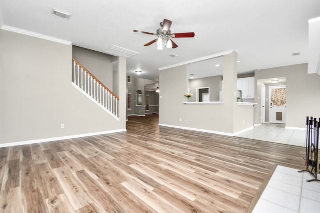 unfurnished living room featuring ceiling fan, light hardwood / wood-style floors, and crown molding