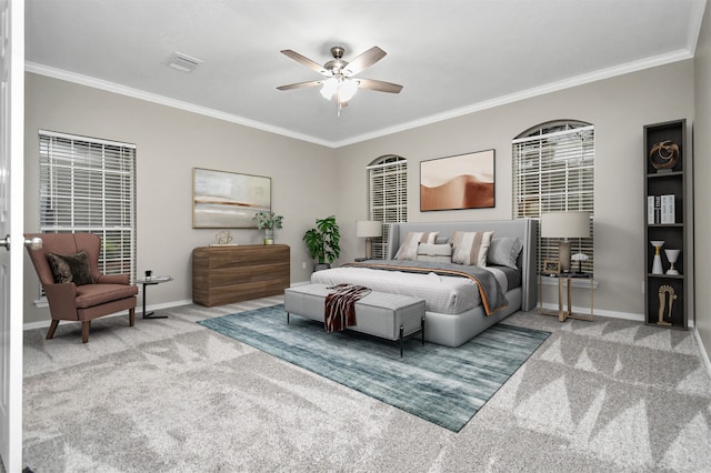 carpeted bedroom with ceiling fan and crown molding