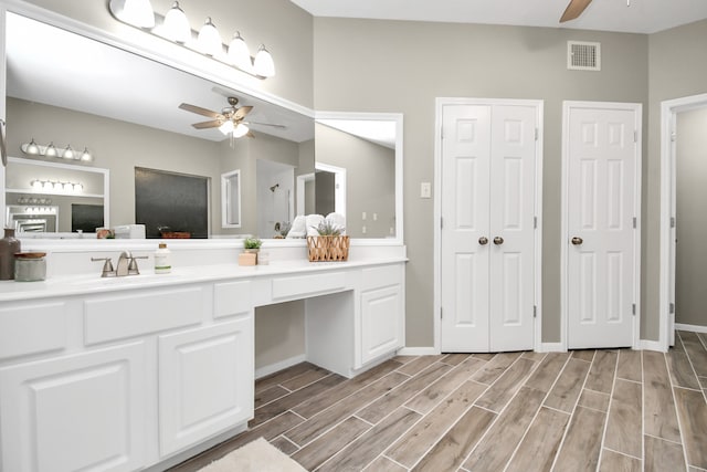 bathroom featuring hardwood / wood-style flooring, ceiling fan, and vanity