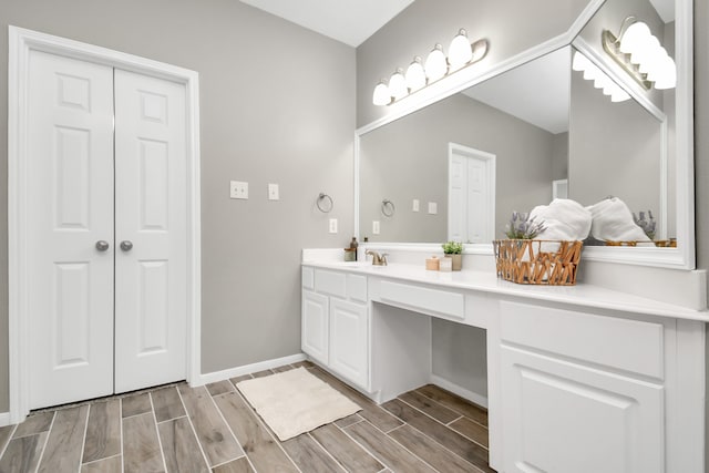 bathroom with hardwood / wood-style floors and vanity